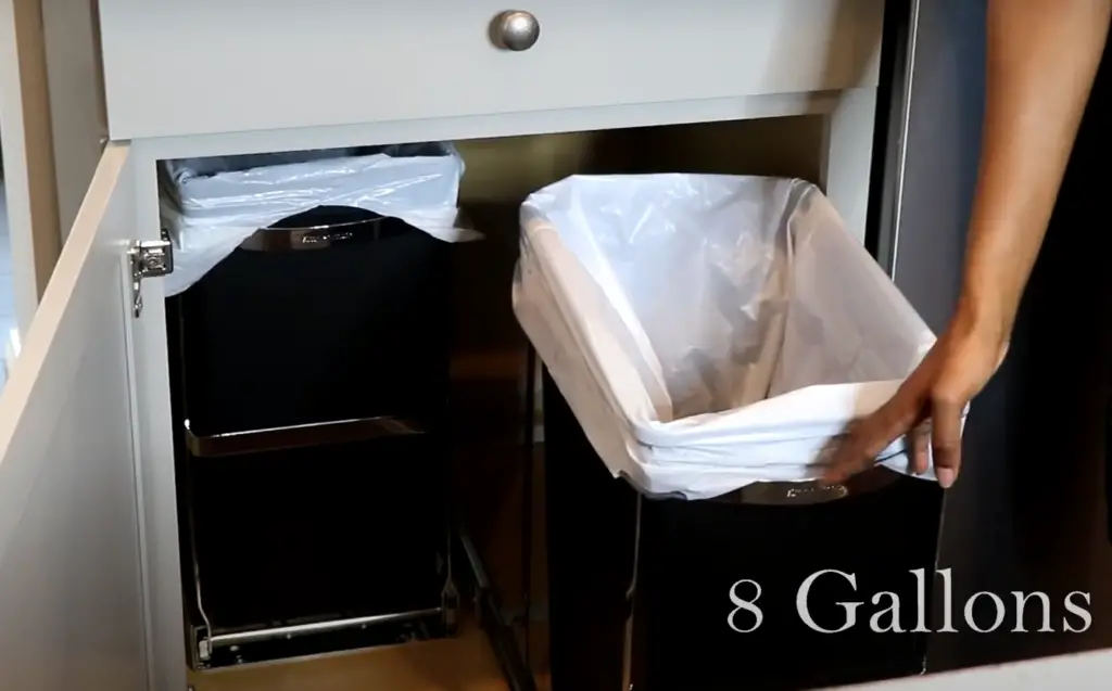 How often should I empty my kitchen trash bin?
