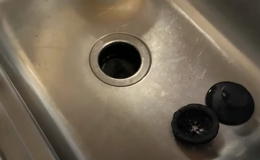 How do I get rid of grease buildup in my kitchen sink?