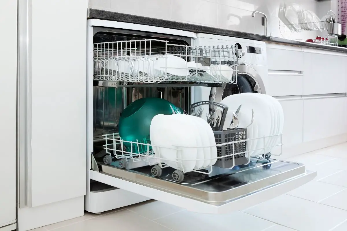 What causes water to stand in the bottom of a dishwasher